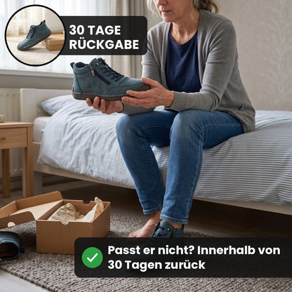 Frau auf dem Bett probiert den MayFit Zip in Petrol an