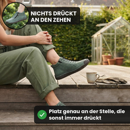 Frau auf einer Gartenterrasse trägt den grünen MayFit Zip