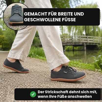Dunkelgraue Ruimevo® Sneaker beim Spaziergang im Park am Wasser, oben der Schuh im Detail